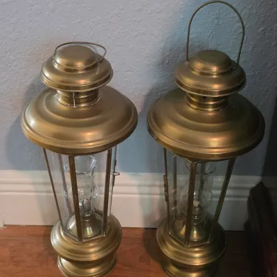 Pair of vintage brass-finish lanterns with etched glass panels and top loop carrying handles.