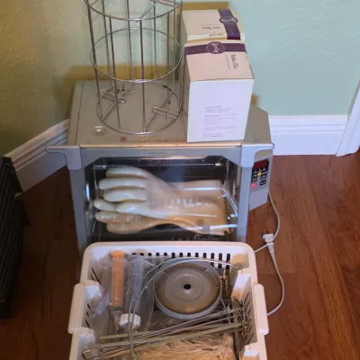 Ronco Showtime rotisserie oven with wire basket and accessories, accompanied by two boxed Scentsy products.