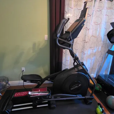 Sole modern black elliptical trainer, shown in good condition on a protective floor mat.