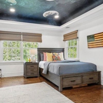 Sale Photo Thumbnail #15: Contemporary bedroom set featuring a grey wooden platform bed with under-bed storage drawers and matching three-drawer nightstand, accompanied by various electric guitars.