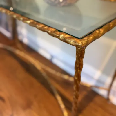 Sale Photo Thumbnail #36: Glass-top console table with a textured gilt metal frame and twisted legs.