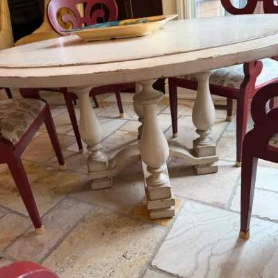 Sale Photo Thumbnail #173: Off-white distressed finish dining table with baluster-style pedestal legs, surrounded by red accent chairs with carved scroll backs.