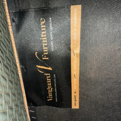 Sale Photo Thumbnail #87: Vanguard Furniture manufacturer's tag attached to textured upholstery, displaying the Hickory, North Carolina origin.