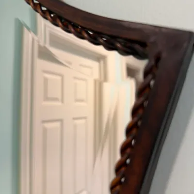 Sale Photo Thumbnail #161: Dark wood framed wall mirror featuring a carved twist accent border.