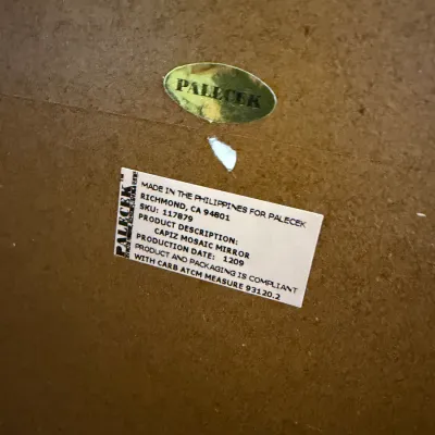 Sale Photo Thumbnail #203: Manufacturer's label on the back of a Palecek Capiz Mosaic Mirror, made in the Philippines.