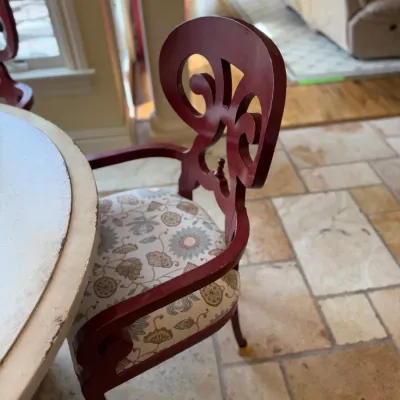 Sale Photo Thumbnail #172: Vintage painted red armchair with an ornate carved splat back and floral patterned upholstered seat.
