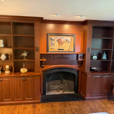 Sale Photo Thumbnail #44: Large custom cherry wood built-in wall unit featuring flanked bookcases with lower cabinet storage and an integrated fireplace mantle.