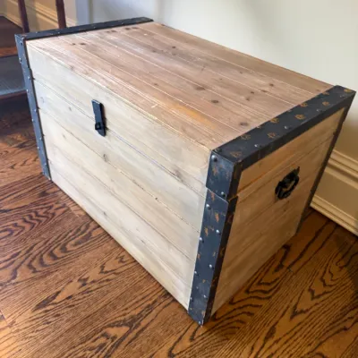 Sale Photo Thumbnail #41: Rustic weathered wood trunk featuring distressed metal corner hardware, side drop handles, and a front latch.