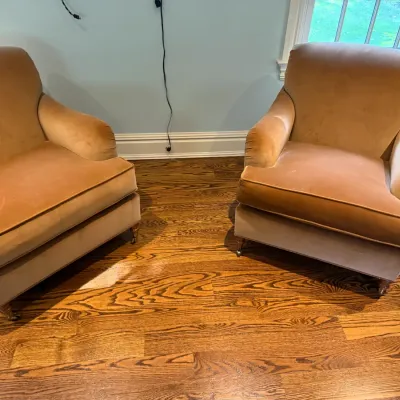 Sale Photo Thumbnail #88: Pair of vintage plush gold velvet armchairs featuring turned wooden legs with brass casters.