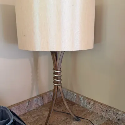 Sale Photo Thumbnail #181: Modern table lamp with a dark metal tripod base, coiled central accent, and a large beige drum shade.
