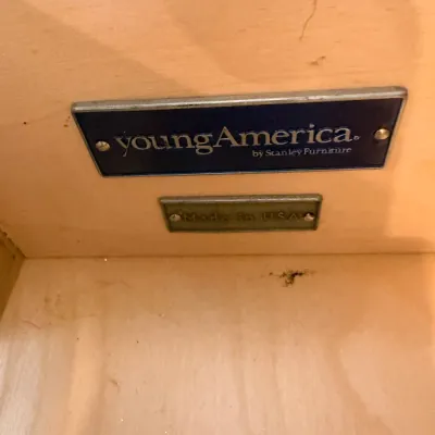 Sale Photo Thumbnail #197: Young America by Stanley Furniture maker's mark and 'Made in USA' plaque inside a wooden drawer.