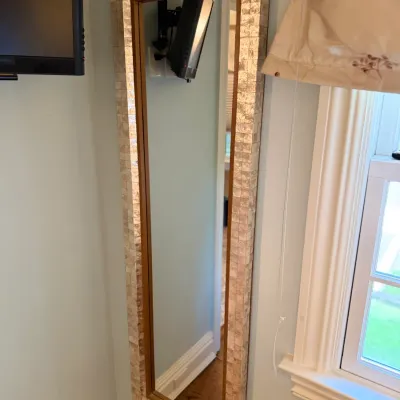 Sale Photo Thumbnail #98: Tall full-length wall mirror with a mother-of-pearl shell tile mosaic frame.