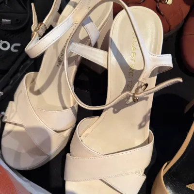 Sale Photo Thumbnail #107: Stuart Weitzman off-white leather platform sandals with crisscross straps and ankle buckles.