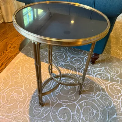 Sale Photo Thumbnail #34: Hollywood Regency style brass faux-bamboo side table with a black glass top and curved stretcher base.