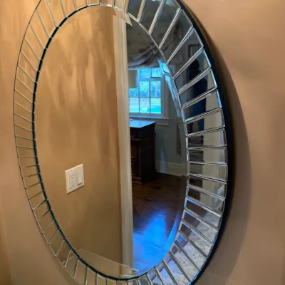Sale Photo Thumbnail #114: Large oval wall mirror featuring a decorative sunburst border of segmented mirror tiles.