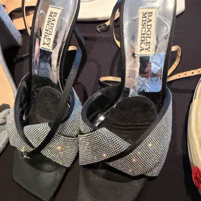 Sale Photo Thumbnail #104: Pair of Badgley Mischka black satin high-heeled sandals featuring crisscross straps encrusted with rhinestones.