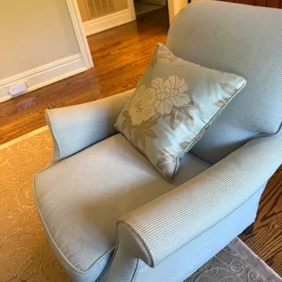 Sale Photo Thumbnail #31: Light blue ribbed fabric armchair with a matching floral accent pillow.