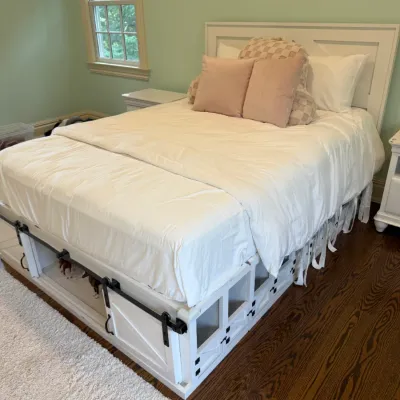Sale Photo Thumbnail #165: Modern farmhouse style white wooden queen bed frame featuring built-in under-bed storage with sliding barn doors.