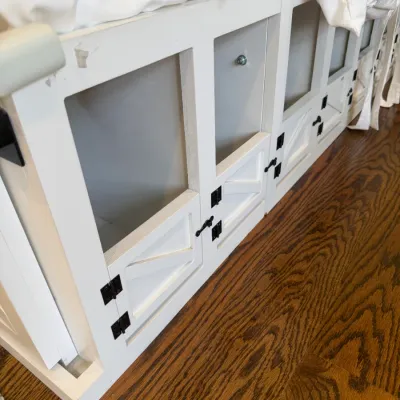 Sale Photo Thumbnail #166: White painted wooden bed frame featuring built-in lower dog crates with farmhouse-style barn door gates and black hardware.