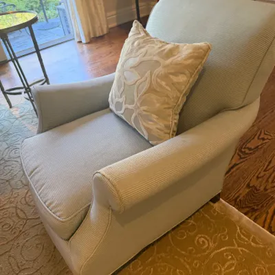 Sale Photo Thumbnail #27: Upholstered light blue armchair featuring rolled arms, textured stripe fabric, and an embroidered accent pillow.