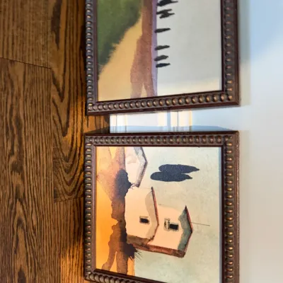 Sale Photo Thumbnail #115: Pair of framed miniature landscape prints depicting Mediterranean-style countryside scenes in dark wooden frames with beaded detail.