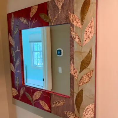 Sale Photo Thumbnail #157: Contemporary square wall mirror featuring a wide art frame with mixed-media textured leaf motifs and metallic detailing in rich earth tones.