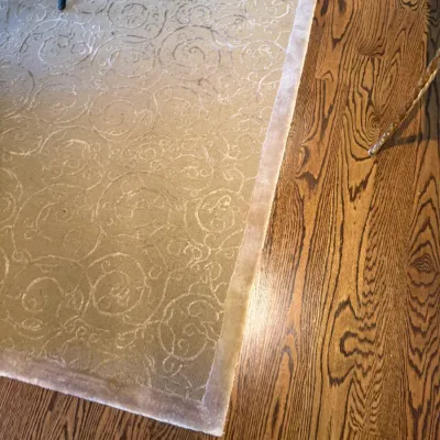 Sale Photo Thumbnail #54: Beige tone-on-tone patterned area rug with a solid border, displayed on hardwood flooring.