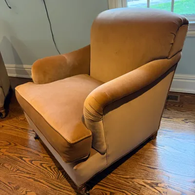 Sale Photo Thumbnail #89: Vintage golden velvet club chair with rolled arms and caster feet, showing light wear.