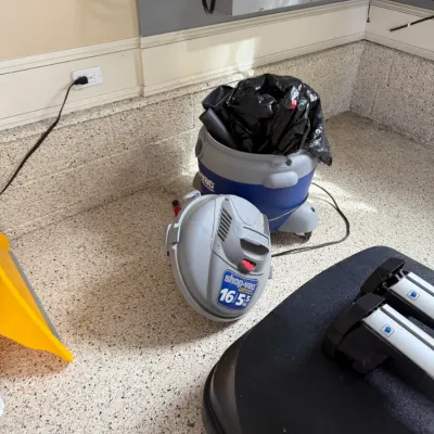 Sale Photo Thumbnail #128: Shop-Vac 16-gallon 5.5 peak HP wet/dry vacuum with detached motor head, situated on a speckled garage floor.