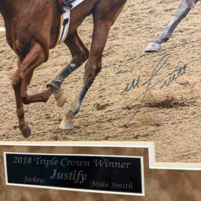 Sale Photo Thumbnail #49: Autographed framed photograph of 2018 Triple Crown winner Justify, signed by jockey Mike Smith with an engraved commemorative plaque.
