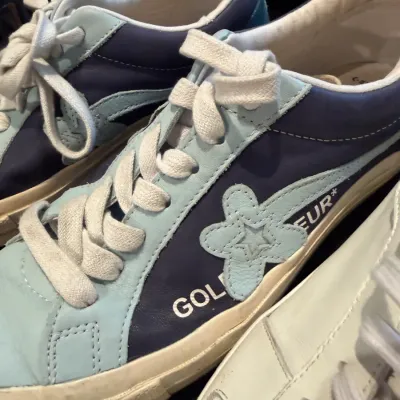 Sale Photo Thumbnail #102: Pair of Golf le Fleur x Converse One Star low-top sneakers in two-tone blue leather, showing light wear.