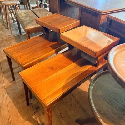 Pair of mid-century modern two-tier walnut end tables featuring tapered legs and a warm natural finish.