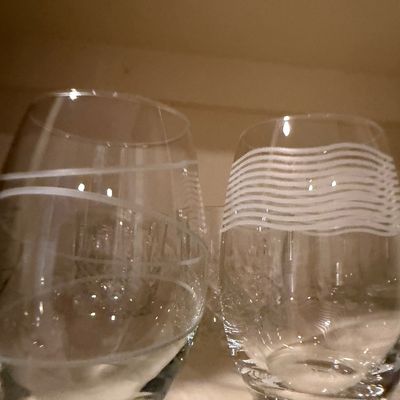 Sale Photo Thumbnail #52: Pair of modern stemless wine glasses featuring etched white line motifs, including diagonal and wavy bands.