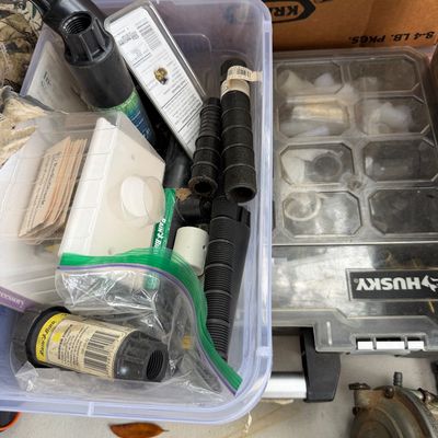 Sale Photo Thumbnail #89: Clear plastic storage tote filled with various sprinkler heads, irrigation fittings, and small hardware accessories alongside a Husky compartment organizer.