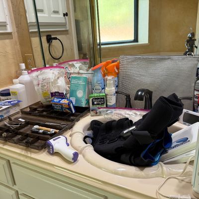Sale Photo Thumbnail #34: Assorted personal care items, toiletries, medical accessories, and dental products arranged on a bathroom counter.