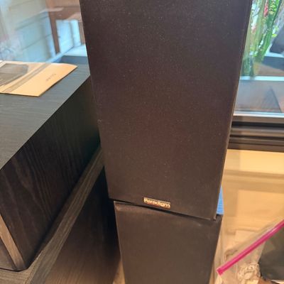 Sale Photo Thumbnail #113: Stacked pair of vintage Paradigm bookshelf speakers with black fabric grilles and wood-grained cabinets.