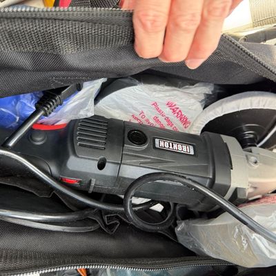 Sale Photo Thumbnail #95: Ironton corded electric rotary polisher with bonnet attachment and accessories, packed inside a black canvas tool bag.