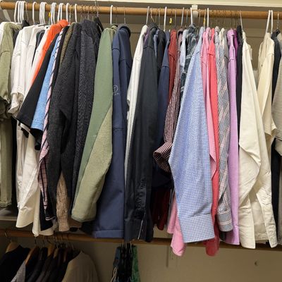 Sale Photo Thumbnail #23: Closet full of men's contemporary casual clothing, including t-shirts, button-downs, sweaters, and light jackets hanging on a wooden rod.