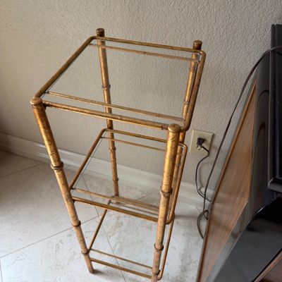 Sale Photo Thumbnail #32: Hollywood Regency style faux bamboo plant stand or etagere featuring a gilt metal frame and glass shelves.