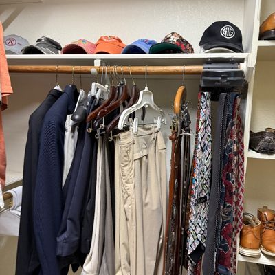 Sale Photo Thumbnail #25: Closet filled with men's apparel including suit jackets, slacks, neckties, leather belts, and baseball caps.