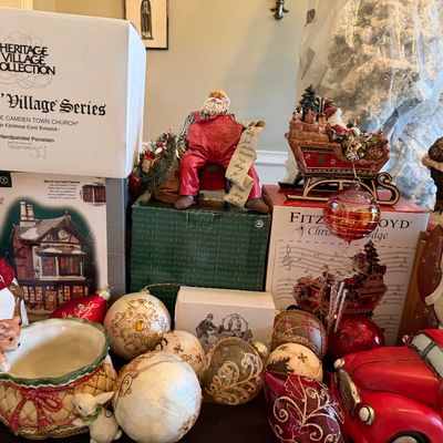 Sale Photo Thumbnail #6: Collection of Christmas decorations and collectibles, featuring Department 56 Dickens' Village and Fitz and Floyd boxes, Santa figurines, ornaments, and a snowman cookie jar.