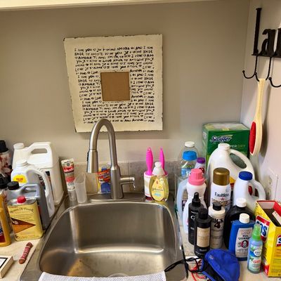 Sale Photo Thumbnail #72: Collection of various household cleaning supplies, laundry products, polishers, and detergents displayed around a utility sink.