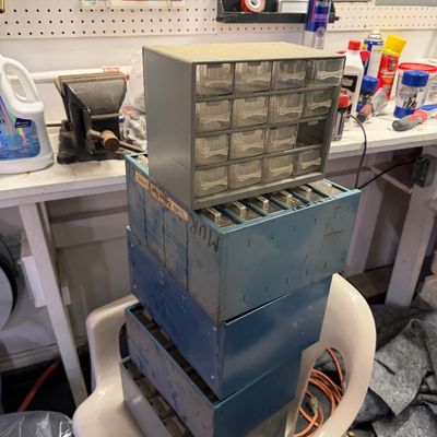 Sale Photo Thumbnail #108: Stack of vintage workshop small parts organizers, including a grey plastic multi-drawer cabinet and several blue metal divider trays.