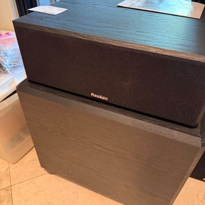 Sale Photo Thumbnail #112: Paradigm center channel speaker resting atop a black wood-grained subwoofer in good cosmetic condition.