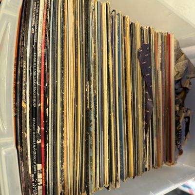 Sale Photo Thumbnail #109: Collection of vintage 33 RPM vinyl records stacked upright in a plastic storage bin, featuring various classic rock and pop artists.