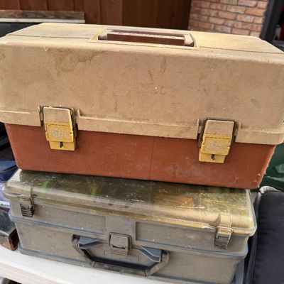 Sale Photo Thumbnail #99: Vintage Plano molded plastic tackle box stacked on a grey tool organizer case, showing light wear and dust.