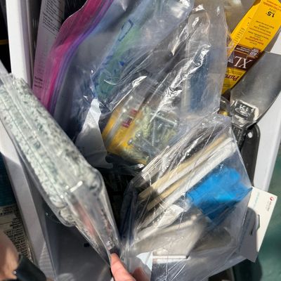 Sale Photo Thumbnail #93: Plastic tote bin filled with assorted household hardware, paint supplies, and wall anchors organized in bags.