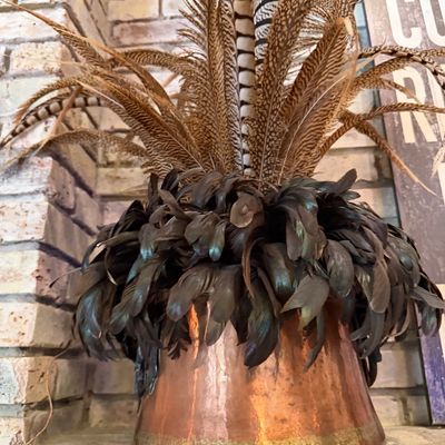 Sale Photo Thumbnail #42: Rustic decorative feather arrangement set inside a hammered copper vessel.