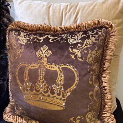 Sale Photo Thumbnail #64: Brown velvet throw pillow featuring a gold crown and scroll motif embellished with rhinestones, complete with ruched fabric trim and corded piping.