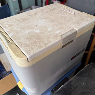 Sale Photo Thumbnail #70: Vintage Igloo portable electric mini refrigerator-cooler in a gray and off-white plastic casing, displaying heavy surface dirt and wear.
